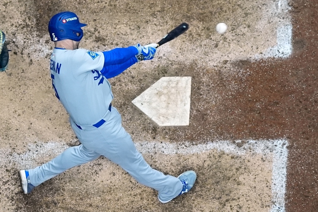 Los Angeles Dodgers' Freddie Freeman hits a double during the eighth inning of Game 1 of baseball's National League Championship Series against the Milwaukee Brewers Monday, Oct. 13, 2025, in Milwaukee. (AP Photo/Morry Gash)