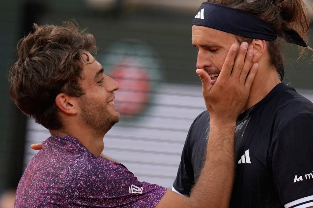 Second placed Flavio Cobolli of Italy, left, greets winner Alexander Zverev of Germany after their men's final match at the French Open tennis tournament in Paris, Sunday, June 7, 2026. (AP Photo/Christophe Ena)