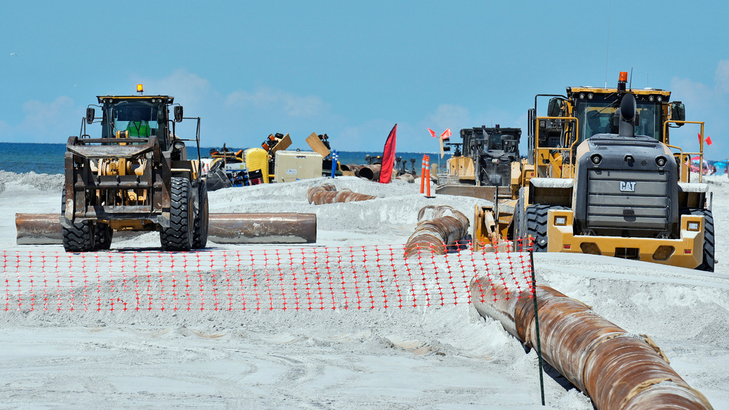 Workers replace the sand washed away by recent hurricanes along the gulf Thursday, Sept. 25, 2025, in Indian Rocks Beach, Fla. (AP Photo/Chris O'Meara)