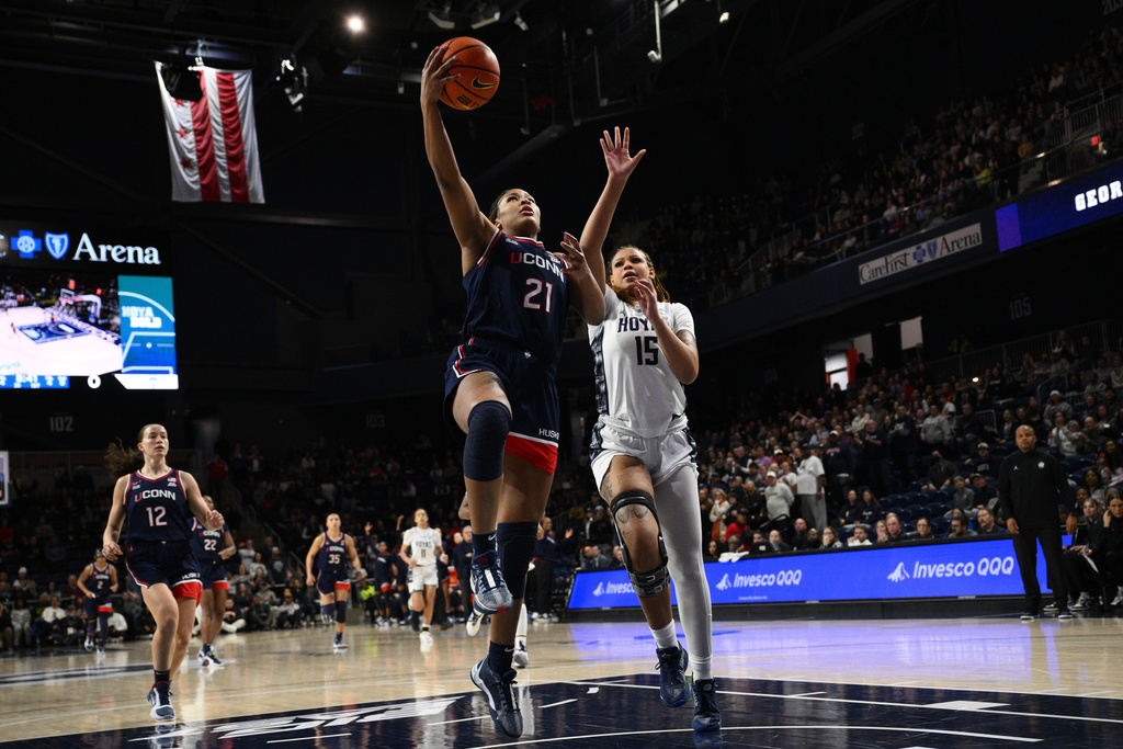 UConn forward Sarah Strong (21) goes to the basket against Georgetown forward Brianna Scott (15) during the first half of an NCAA college basketball game, Thursday, Jan. 22, 2026, in Washington. (AP Photo/Nick Wass)