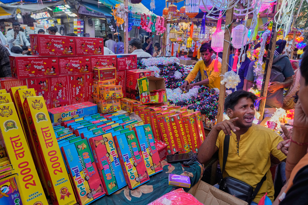 A roadside shopkeeper sells green firecrackers after the Supreme Court permitted sales ahead of the Diwali festival in New Delhi, India, Thursday, Oct. 16, 2025. (AP Photo/Manish Swarup)