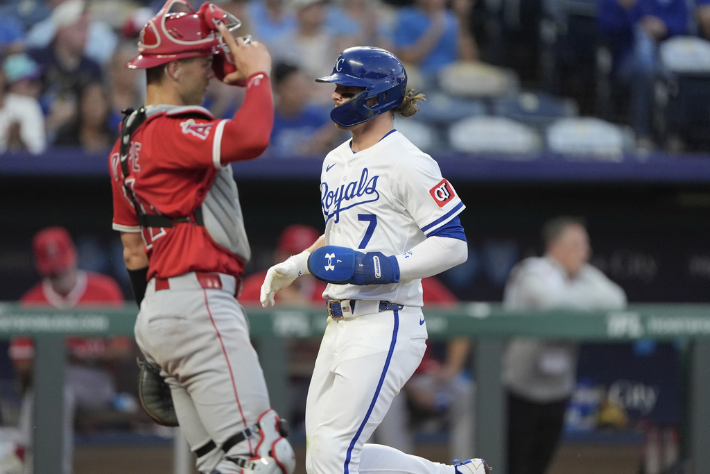 Kansas City Royals' Bobby Witt Jr. (7) crosses the plate past Los Angeles Angels catcher Logan O'Hoppe to score on a sacrifice fly by Vinnie Pasquantino during the third inning of a baseball game Tuesday, Sept. 2, 2025, in Kansas City, Mo. (AP Photo/Charlie Riedel)