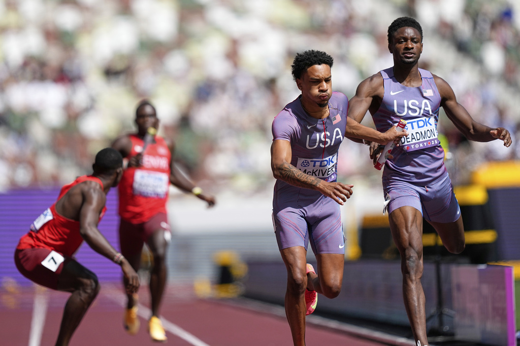 United States' Jenoah McKiver takes the baton from Bryce Deadmon to race the anchor leg in a run-off heat against Kenya in the men's 4x400 meters relay at the World Athletics Championships in Tokyo, Sunday, Sept. 21, 2025. (AP Photo/Petr David Josek)