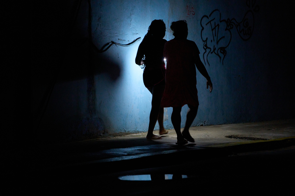 People walk in the night during a blackout in Havana, Cuba, Friday, July 10, 2026. (AP Photo/Ramon Espinosa)