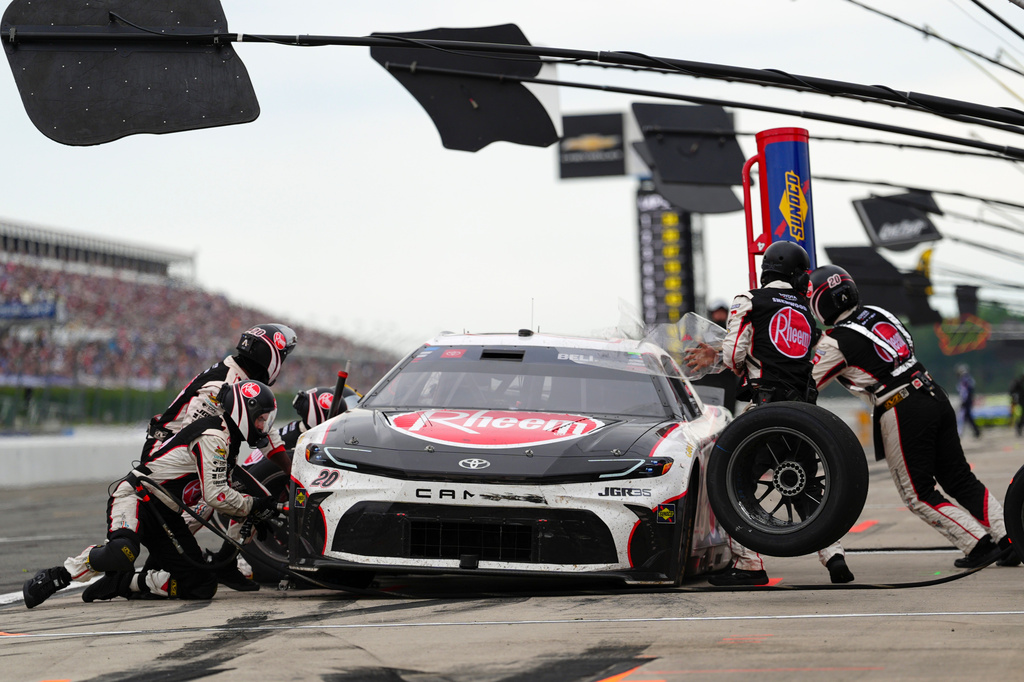 Christopher Bell makes a pitstop during a NASCAR Cup Series auto race at Pocono Raceway, Sunday, June 14, 2026, in Long Pond, Pa. (AP Photo/Derik Hamilton)