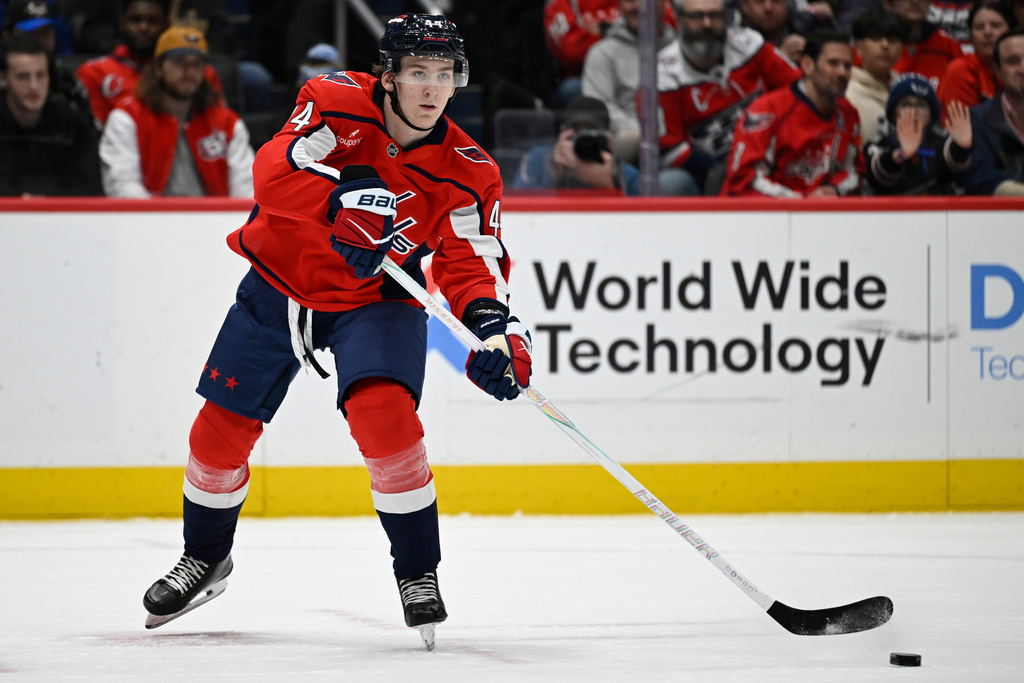 Washington Capitals defenseman Cole Hutson passes off in his first NHL game during the second period of an NHL hockey game against the Ottawa Senators, Wednesday, March 18, 2026, in Washington. (AP Photo/John McDonnell)