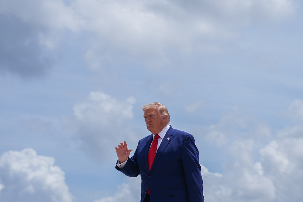 President Donald Trump waves to reporters after arriving on Air Force One at Dobbins Air Reserve Base, Wednesday, July 22, 2026, in Marietta, Ga. (AP Photo/Julia Demaree Nikhinson)