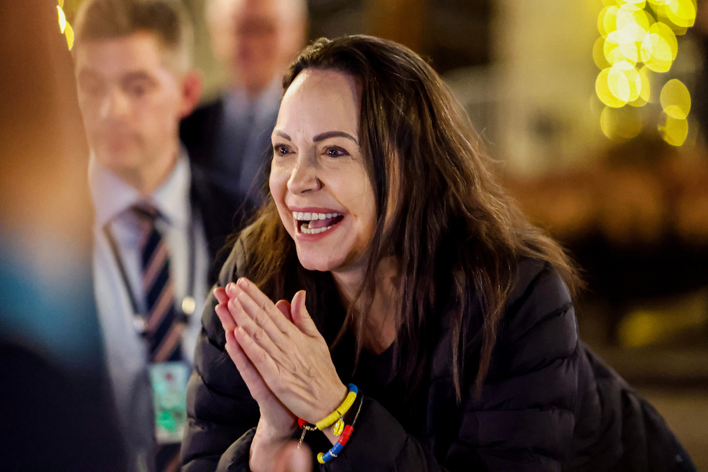 Nobel Peace Prize laureate Maria Corina Machado reacts to the crowd gathered in front of the Grand Hotel, in Oslo, Norway, early Thursday, Dec. 11, 2025. (Jonas Been Henriksen/NTB Scanpix via AP)