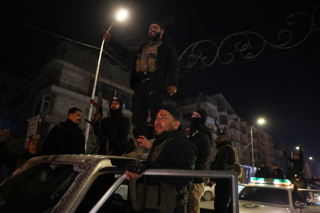 Members of Syrian government forces deploy on the streets as they take over the Achrafieh neighborhood from Kurdish fighters during ongoing clashes that erupted Tuesday in a contested area of the northern city of Aleppo, Syria, Thursday, Jan. 8, 2026. (AP Photo/Omar Albam)
