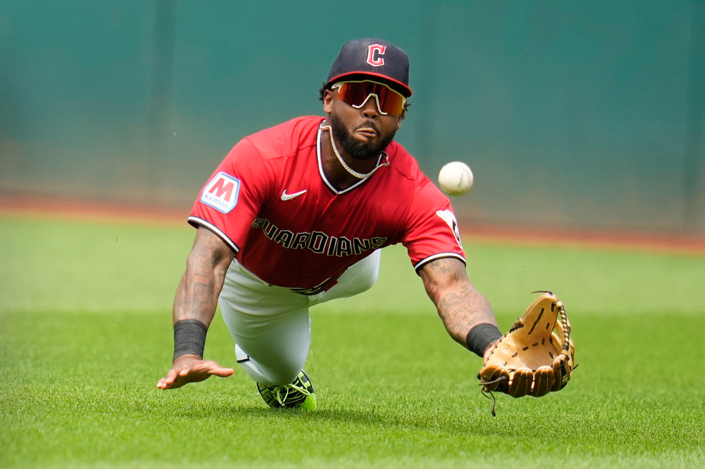 Cleveland Guardians center fielder Kahlil Watson dives for but misses a ball hit by Pittsburgh Pirates' Tyler Callihan for a double in the first inning of the first baseball game of a split doubleheader in Cleveland, Saturday, June 18, 2026. (AP Photo/Sue Ogrocki)
