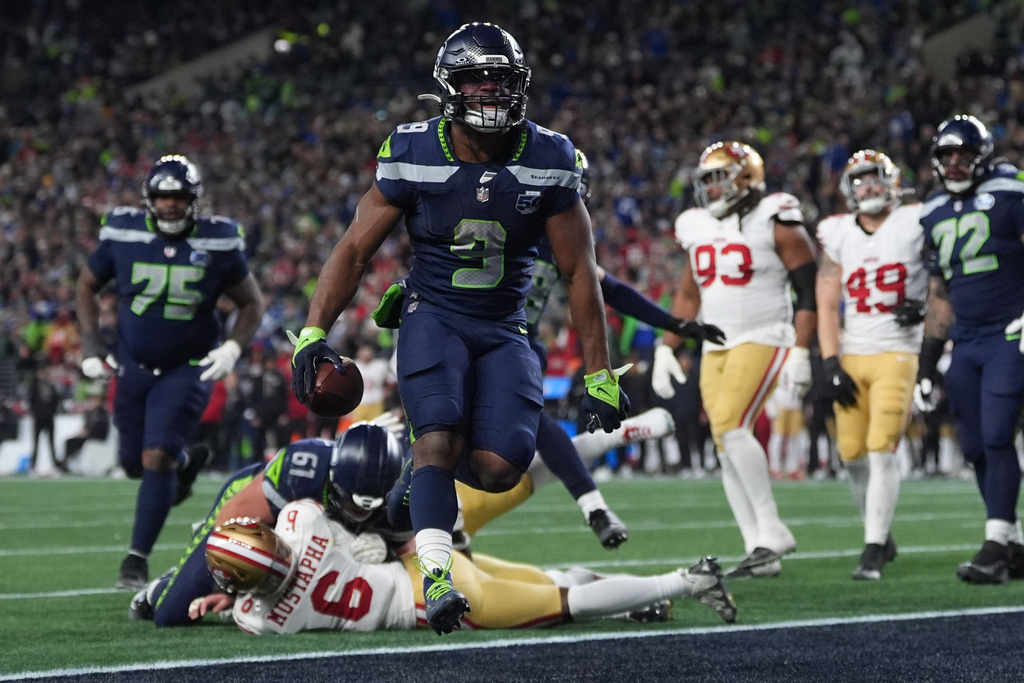 Seattle Seahawks running back Kenneth Walker III (9) scores a touchdown during the second half of an NFL football divisional playoff game against the San Francisco 49ers, Saturday, Jan. 17, 2026, in Seattle. (AP Photo/Lindsey Wasson)