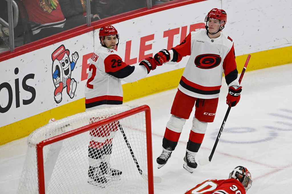 Carolina Hurricanes' Logan Stankoven (22) celebrates with teammate Jackson Blake (53) after scoring a goal during the second period of an NHL hockey game against the Chicago Blackhawks in Chicago, Thursday, April 9, 2026. (AP Photo/Paul Beaty)