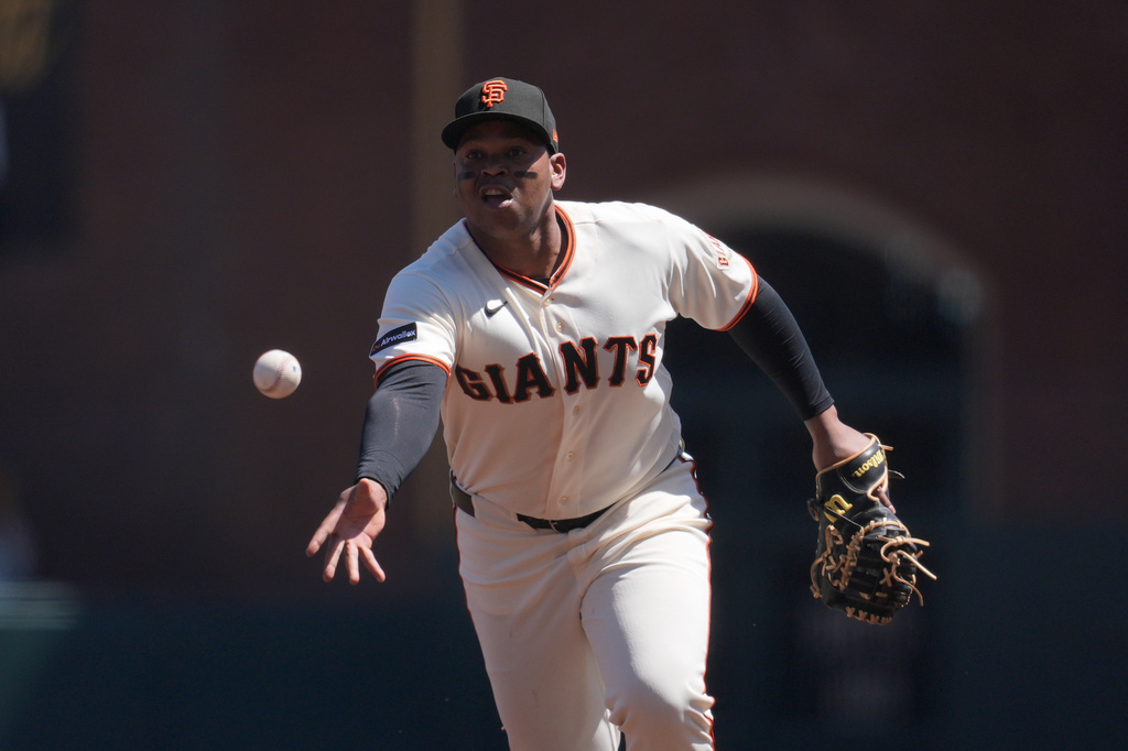 San Francisco Giants first baseman Rafael Devers throws out Philadelphia Phillies' Justin Crawford at first base during the third inning of a baseball game in San Francisco, Wednesday, April 8, 2026. (AP Photo/Jeff Chiu)
