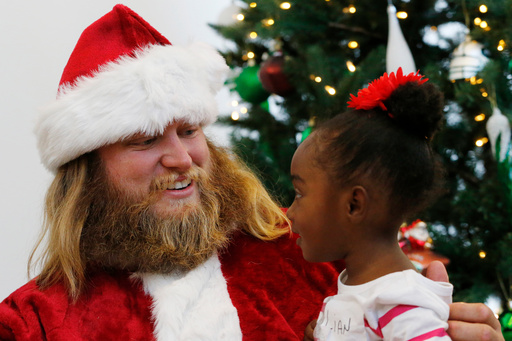 FILE - Lian Taylor, 2, right, of Bayonne, N.J., sits on the lap of New York Jets center Nick Mangold posing as Santa Claus during the team's holiday party for military families, Friday, Dec. 4, 2015, in Florham Park, N.J. (AP Photo/Julio Cortez, File) FILE - Lian Taylor, 2, right, of Bayonne, N.J., sits on the lap of New York Jets center Nick Mangold posing as Santa Claus during the team's holiday party for military families, Friday, Dec. 4, 2015, in Florham Park, N.J. (AP Photo/Julio Cortez, File)