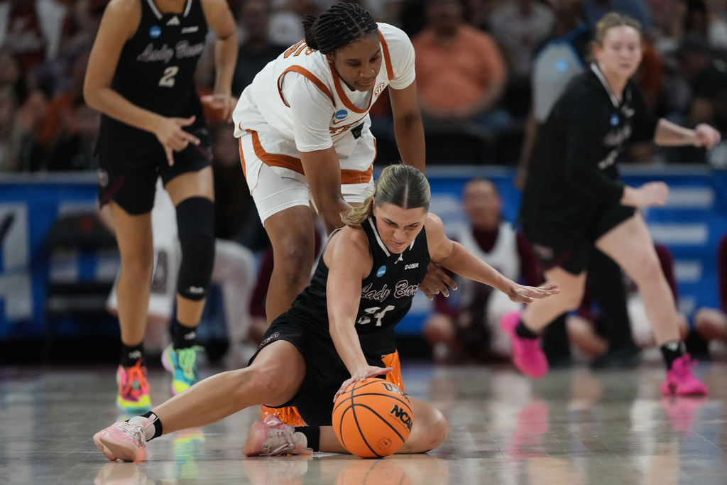 Missouri State guard Kaemyn Bekemeier (24) and Texas forward Madison Booker, center, chase a loose ball during the first half in the first round of the NCAA college basketball tournament game, Friday, March 20, 2026. (AP Photo/Eric Gay)
