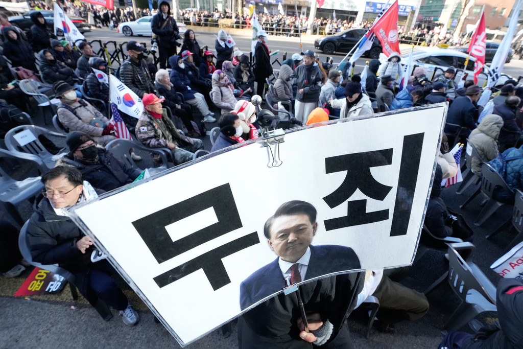 Supporters of former South Korean President Yoon Suk Yeol stage a rally outside of Seoul Central District Court in Seoul, South Korea, Thursday, Feb. 19, 2026. A sign reads "Not Guilty." (AP Photo/Ahn Young-joon)