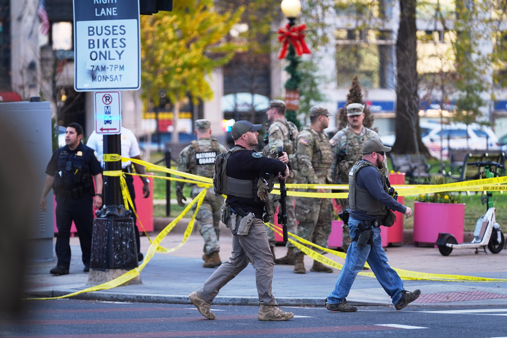 U.S. Marshals and National Guard troops are seen after reports of two National Guard soldiers shot near the White House in Washington, Wednesday, Nov. 26, 2025. (AP Photo/Evan Vucci)