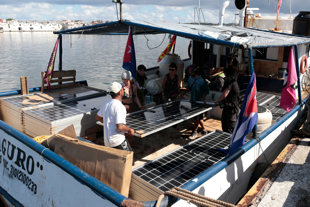 Activists from the vessel Maguro, that arrived from Mexico, unload solar panels and other humanitarian aid from the "Nuestra America," or Our America convoy, at the port in Havana Bay, Cuba, Tuesday, March 24, 2026. (Jorge Luis Banos/IPS via AP, Pool)