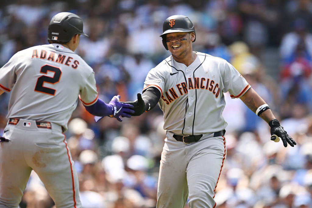 San Francisco Giants' Rafael Devers, right, celebrates with teammate Willy Adames (2) after hitting a solo home run during the sixth inning of a baseball game against the Chicago Cubs in Chicago, Saturday, June 6, 2026. (AP Photo/Paul Beaty)
