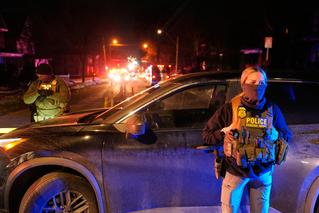 FILE - Federal immigration officers at the scene of a reported shooting Wednesday, Jan. 14, 2026, in Minneapolis. (AP Photo/John Locher, File)