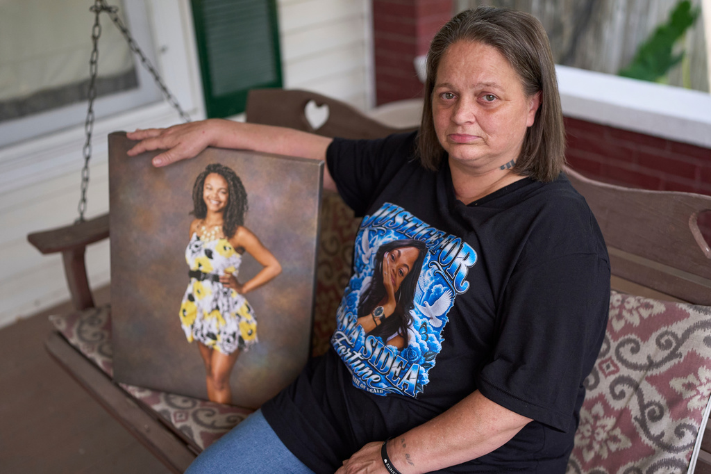 Christy Spivey poses with a portrait of her late daughter, Tasia Fortune, on Tuesday, Sept. 8, 2026, in Marion, Ky. (AP Photo/George Walker IV)