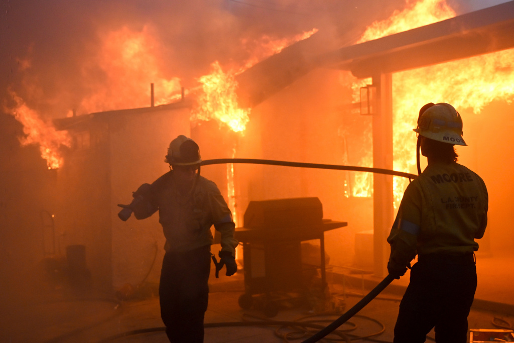 FILE - Firefighters battle the Eaton Fire as it engulfs structures, Jan. 8, 2025 in Altadena, Calif. (AP Photo/Nic Coury, File)