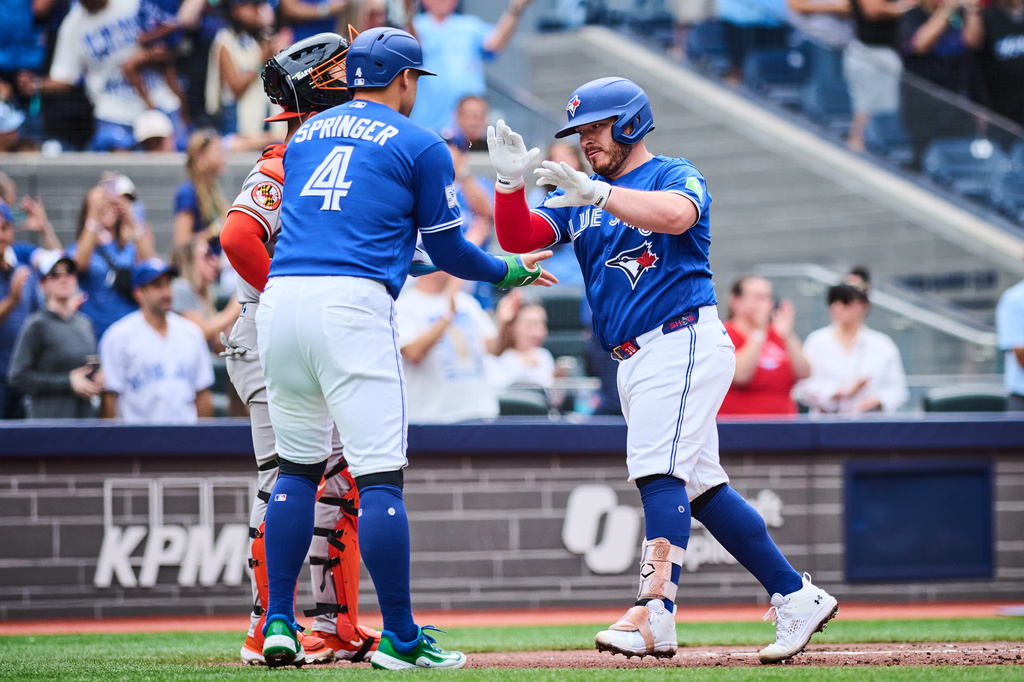 Toronto Blue Jays' Alejandro Kirk (30), right, celebrates his two run home run with George Springer (4) during third inning a baseball game against the Baltimore Orioles in Toronto, on Saturday, Sept. 12, 2026. (Sammy Kogan/The Canadian Press via AP)