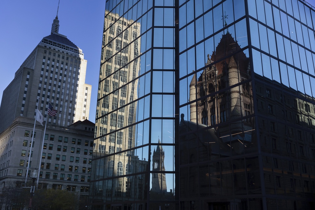 FILE - Buildings are reflected in 200 block of Clarendon Street, Nov. 8, 2022, in Boston. (AP Photo/Michael Dwyer, File)
