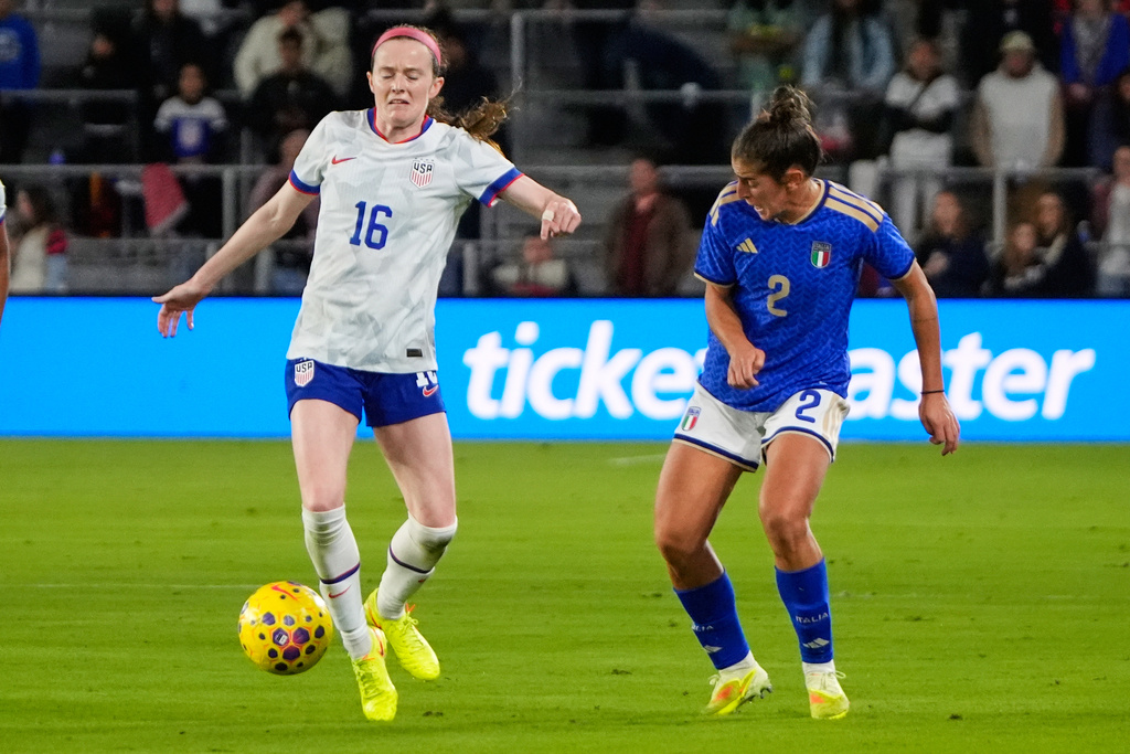 United States midfielder Rose Lavelle (16) stops Italy defender Valentina Bergamaschi (2) from advancing the ball during the first half of an international friendly soccer match Friday, Nov. 28, 2025, in Orlando, Fla. (AP Photo/John Raoux)