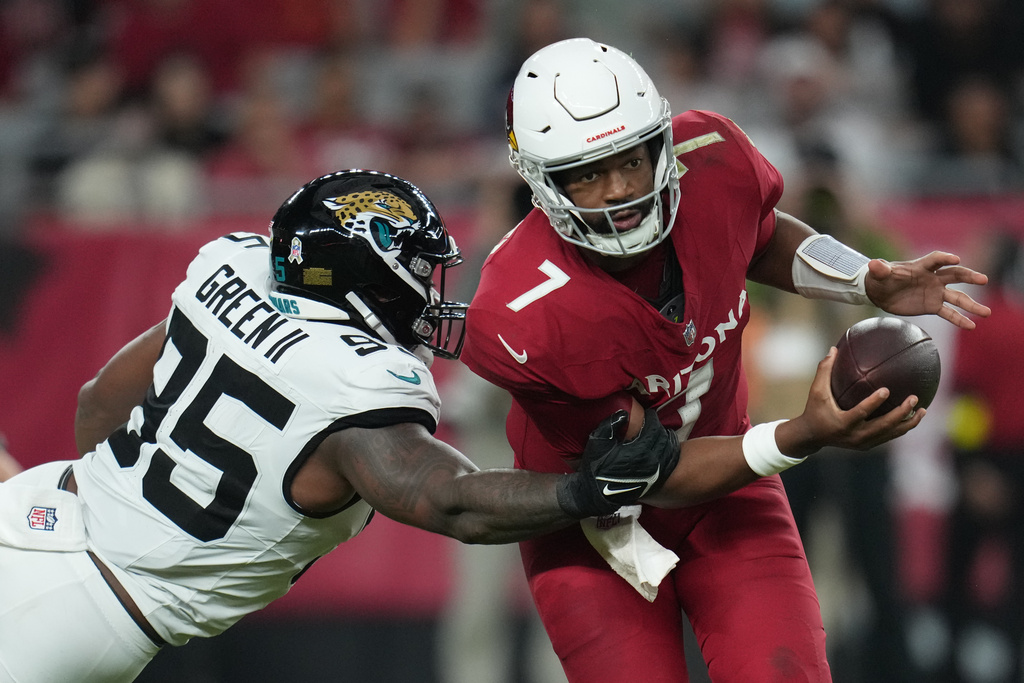 Jacksonville Jaguars defensive end BJ Green II (95) tackles Arizona Cardinals quarterback Jacoby Brissett (7) during the second half of an NFL football game Sunday, Nov. 23, 2025, in Glendale, Ariz. (AP Photo/Rick Scuteri)