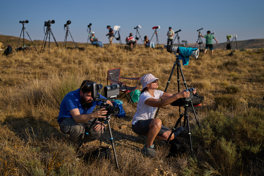 Members of the "Los Taraos" amateur astrophotography group, set up cameras to shoot a total solar eclipse in Berlanga de Duero, central Spain, Wednesday, Aug. 12, 2026. (AP Photo/Bernat Armangue)