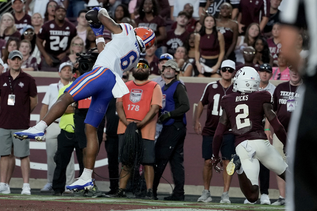 Florida wide receiver Dallas Wilson (6) catches a pass in the end zone for a touchdown as Texas A&M cornerback Dezz Ricks (2) is late to defend during the first half of an NCAA college football game Saturday, Oct. 11, 2025, in College Station, Texas. (AP Photo/Sam Craft)