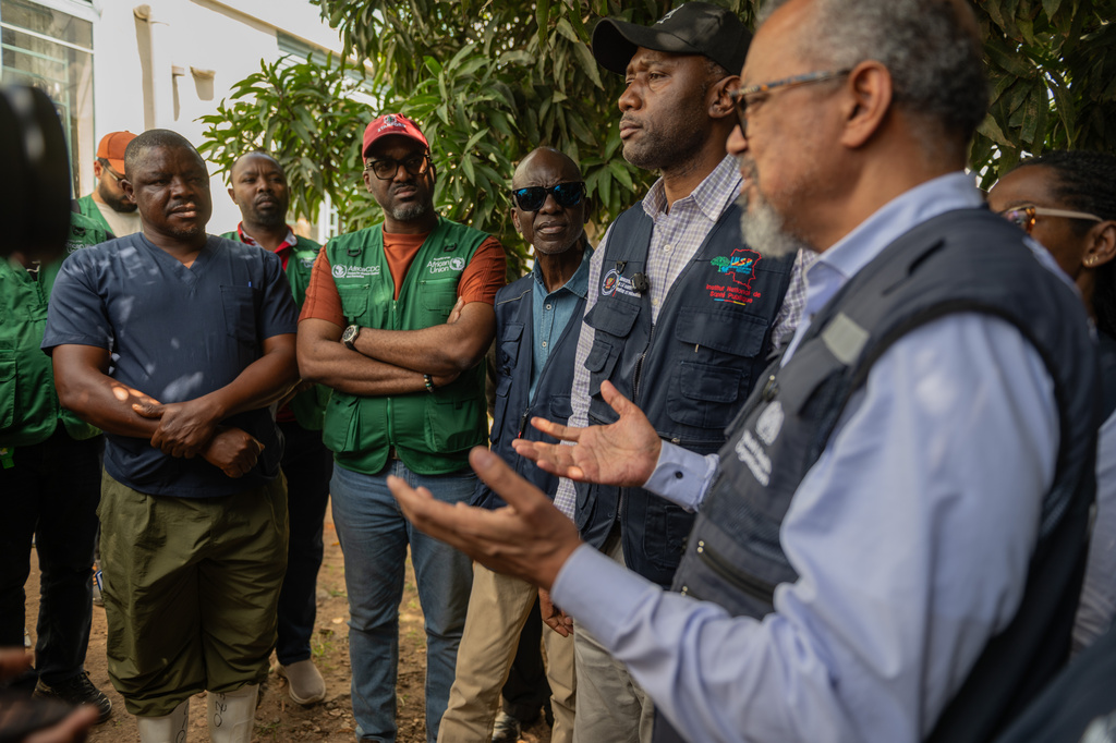 Director General of the World Health Organisation (WHO), Tedros Adhanom Ghebreyesus, meets with health workers who recovered from Ebola in Bunia, Congo, Sunday, May 31, 2026. (AP Photo/Moses Sawasawa)