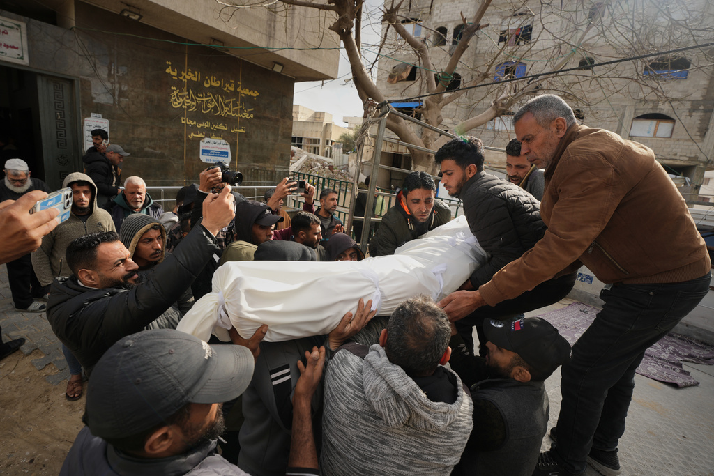 Mourners carry the bodies of two members of Hamas, Muhammad Abu Jabal, and Ali al-Burdini who were killed in an Israeli military strike, at Shifa Hospital in Gaza City Thursday, Feb. 26, 2026. (AP Photo/Jehad Alshrafi)