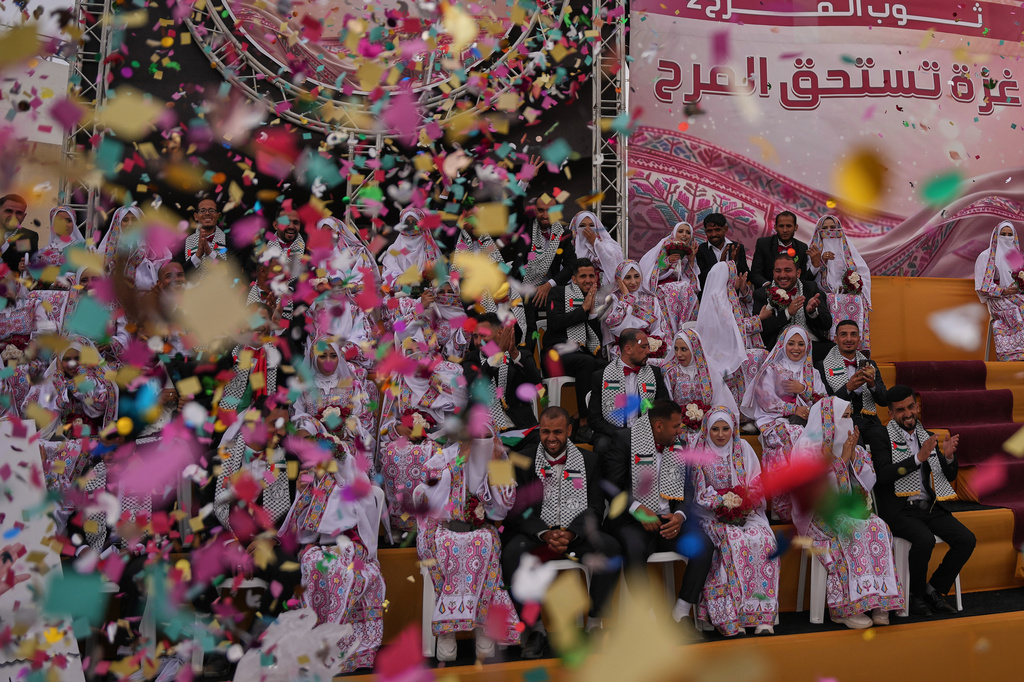 Palestinian couples participate in a mass wedding ceremony in Deir al-Balah, central Gaza Strip, Friday, April 24, 2026. (AP Photo/Abdel Kareem Hana)