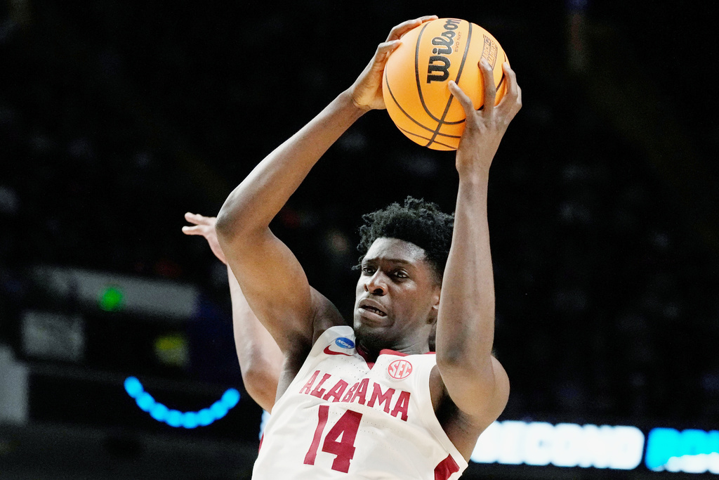 FILE - Alabama center Charles Bediako (14) pulls down a rebound while guarded by Maryland guard Ian Martinez, left, during the second half of a second-round college basketball game in the men's NCAA Tournament in Birmingham, Ala., March 18, 2023. (AP Photo/Rogelio V. Solis, File)