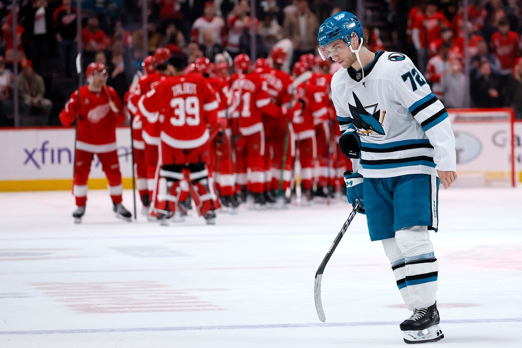 San Jose Sharks left wing William Eklund (72) skates off the ice as Detroit Red Wings players celebrate their win after an NHL hockey game Friday, Jan. 16, 2026, in Detroit. (AP Photo/Duane Burleson)