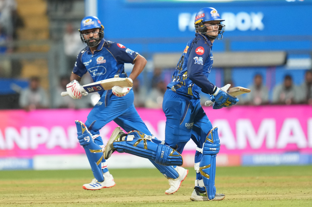 Mumbai Indians' Rohit Sharma, left, and Ryan Rickelton run between the wickets during the Indian Premier League cricket match between Mumbai Indians and Kolkata Knight Riders in Mumbai, India, Sunday, March 29, 2026. (AP Photo/Rafiq Maqbool)