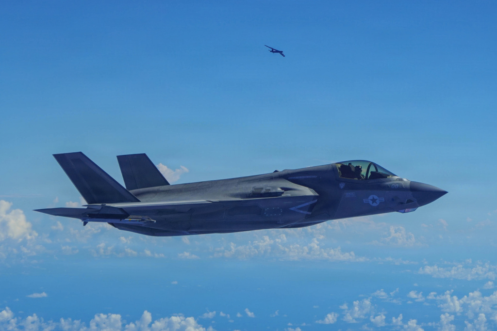 In this image provided by the U.S. Air Force, a Marine Corps F-35B Lightning II aircraft flies alongside a U.S. Air Force B-52H Stratofortress bomber in the U.S. Southern Command area of responsibility, Oct. 15, 2025. (U.S. Air Force via AP)