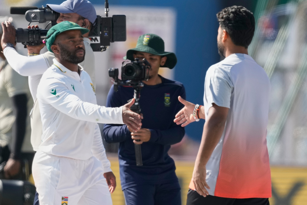 India's captain Rishab Pant, right, and South Africa's captain Temba Bavuma shake hands after South Africa wins the test series against India in Guwahati, India, Saturday, Nov. 22, 2025. (AP Photo/Anupam Nath)