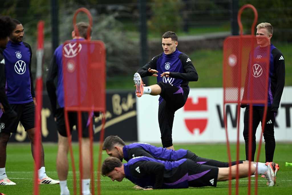 Germany's Florian Wirtz, center, lifts a leg during training session of the German national soccer team in Herzogenaurach, Germany, Tuesday, Oct. 7, 2025, ahead of the World Cup qualifier soccer match against Luxembourg. (Federico Gambarini/dpa via AP)