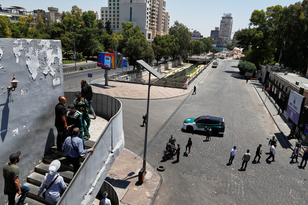 Syrian security forces block the area near the Four Seasons Hotel after two explosions rocked the site earlier while Syrian President Ahmad al-Sharaa was meeting French President Emmanuel Macron at the presidential palace in Damascus, Syria, Tuesday, July 7, 2026. (AP Photo/Omar Sanadiki)