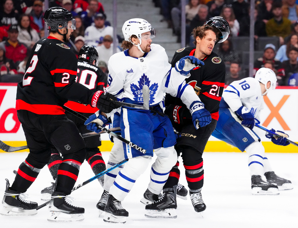 Toronto Maple Leafs' Matias MacCelli (63) collides with Ottawa Senators' Nick Cousins (21) during the first period of an NHL hockey game in Ottawa, Ontario, Wednesday, April 15, 2026. (Sean Kilpatrick/The Canadian Press via AP)