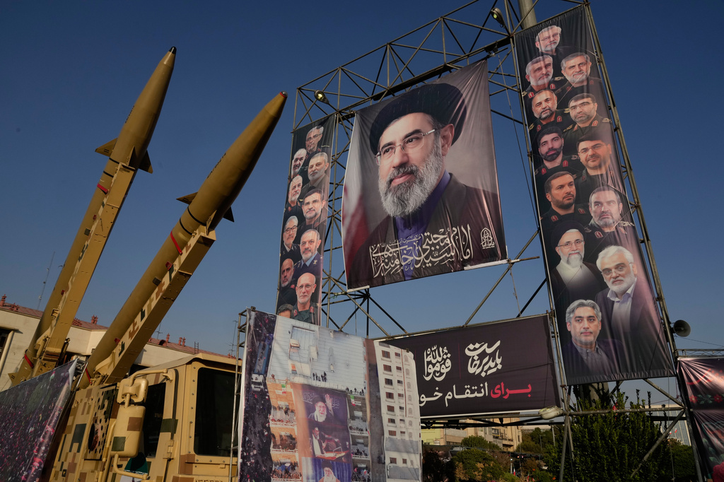 Iranian missiles and banners showing portraits of the Iranian Supreme Leader Ayatollah Mojtaba Khamenei, center, and the late armed forces commanders and nuclear scientists, who were killed in Israel and U.S. strikes, are displayed in a military exhibition commemorating the anniversary of the start of the 1980-88 Iraq-Iran war at Baharestan Square, in Tehran, Monday, Sept. 28, 2026. (AP Photo/Vahid Salemi)