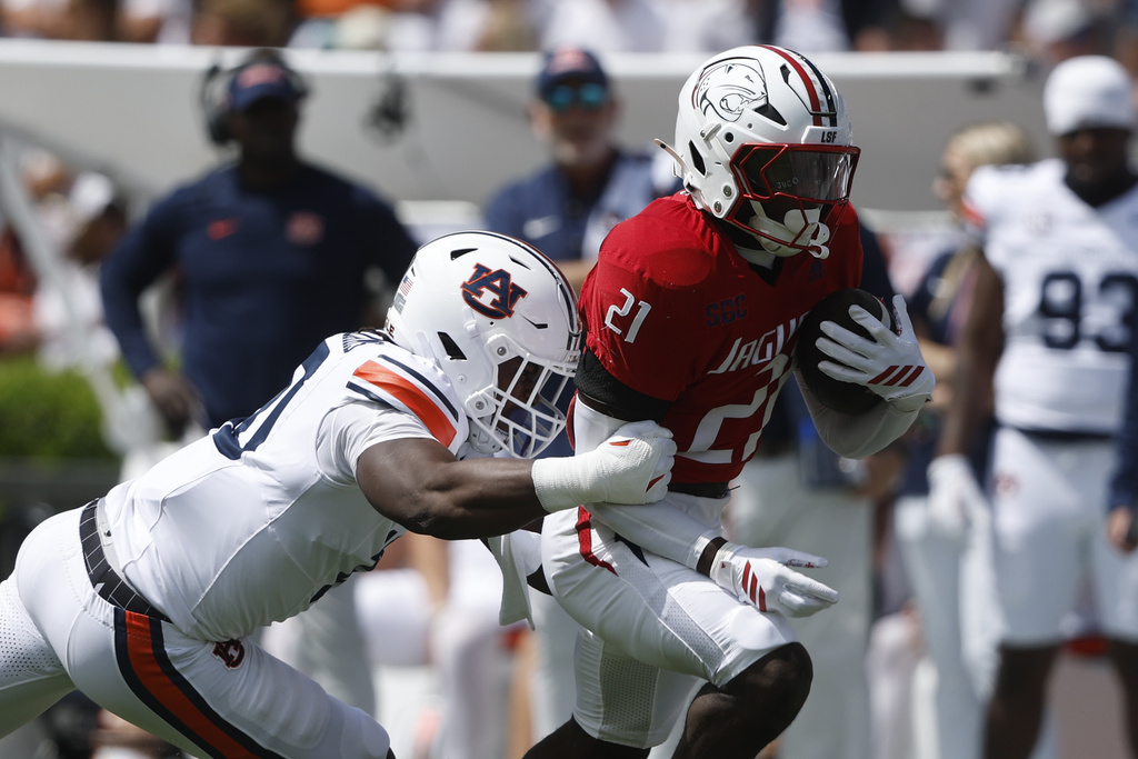 South Alabama running back Keenan Phillips (21) carries the ball as he is tackled by Auburn defensive end Amaris Williams (10) during the first half of an NCAA college football game, Saturday, Sept. 13, 2025, in Auburn, Ala. (AP Photo/Butch Dill)