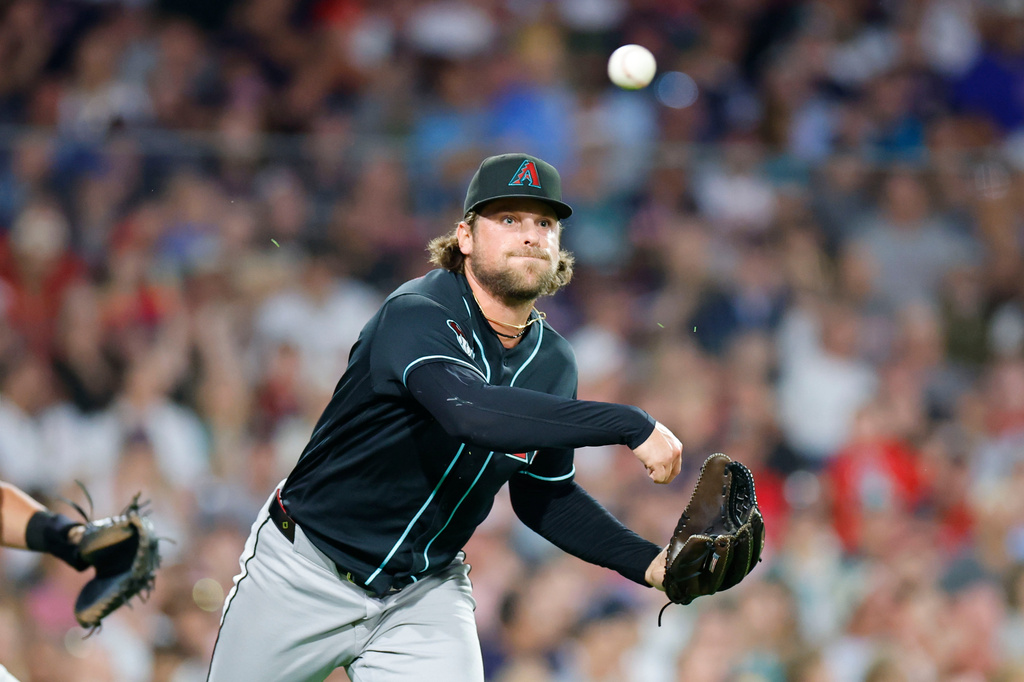 Arizona Diamondbacks pitcher Kevin Ginkel makes a throw to first base during the sixth inning of a baseball game against the Boston Red Sox Tuesday, Aug. 18, 2026, in Boston. (AP Photo/CJ Gunther)