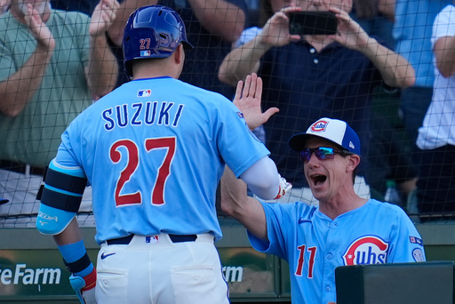 Chicago Cubs' Seiya Suzuki (27), left, high-fives manager Craig Counsell (11) after hitting a grand slam during the seventh inning of a baseball game against the St. Louis Cardinals, Friday, Sept. 26, 2025, in Chicago. (AP Photo/Erin Hooley) Chicago Cubs' Seiya Suzuki (27), left, high-fives manager Craig Counsell (11) after hitting a grand slam during the seventh inning of a baseball game against the St. Louis Cardinals, Friday, Sept. 26, 2025, in Chicago. (AP Photo/Erin Hooley)