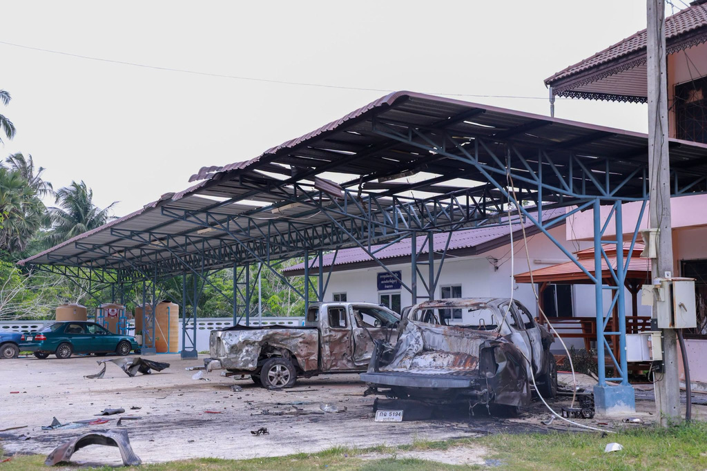 This image provided by The Government's Internal Security Operations Command, shows vehicles damaged the night before by arson at a local government office in Sri Sakhon Subdistrict in Narathiwat province, Thailand, Sunday, Aug. 23, 2026. (The Government's Internal Security Operations Command via AP)