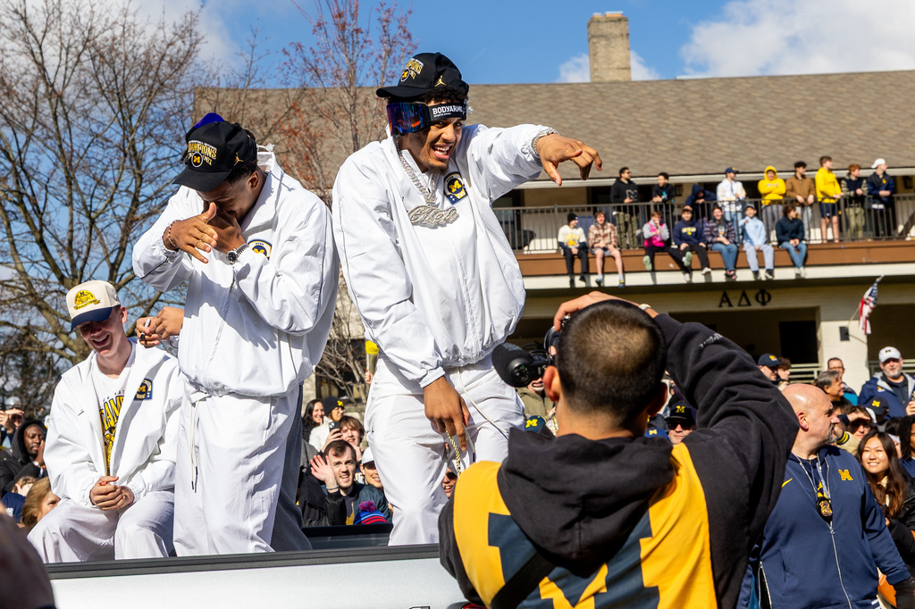 Michigan forward Yaxel Lendeborg , left, and Trey McKenney celebrate during a parade celebrating their national championship win in the NCAA college basketball tournament , Saturday, April 11, 2026, in Ann Arbor, Mich. ( Devin Anderson-Torrez/Ann Arbor News via AP)