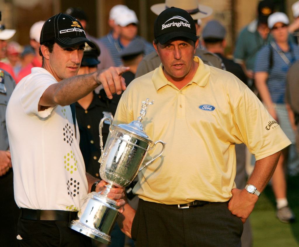 FILE - In this June 18, 2006, file photo, Geoff Ogilvy, left, of Australia, and Phil Mickelson talk on the 18th green where Ogilvy was presented the U.S. Open trophy after winning the golf championship at Winged Foot Golf Club in Mamaroneck, N.Y. (AP Photo/Morry Gash, File)